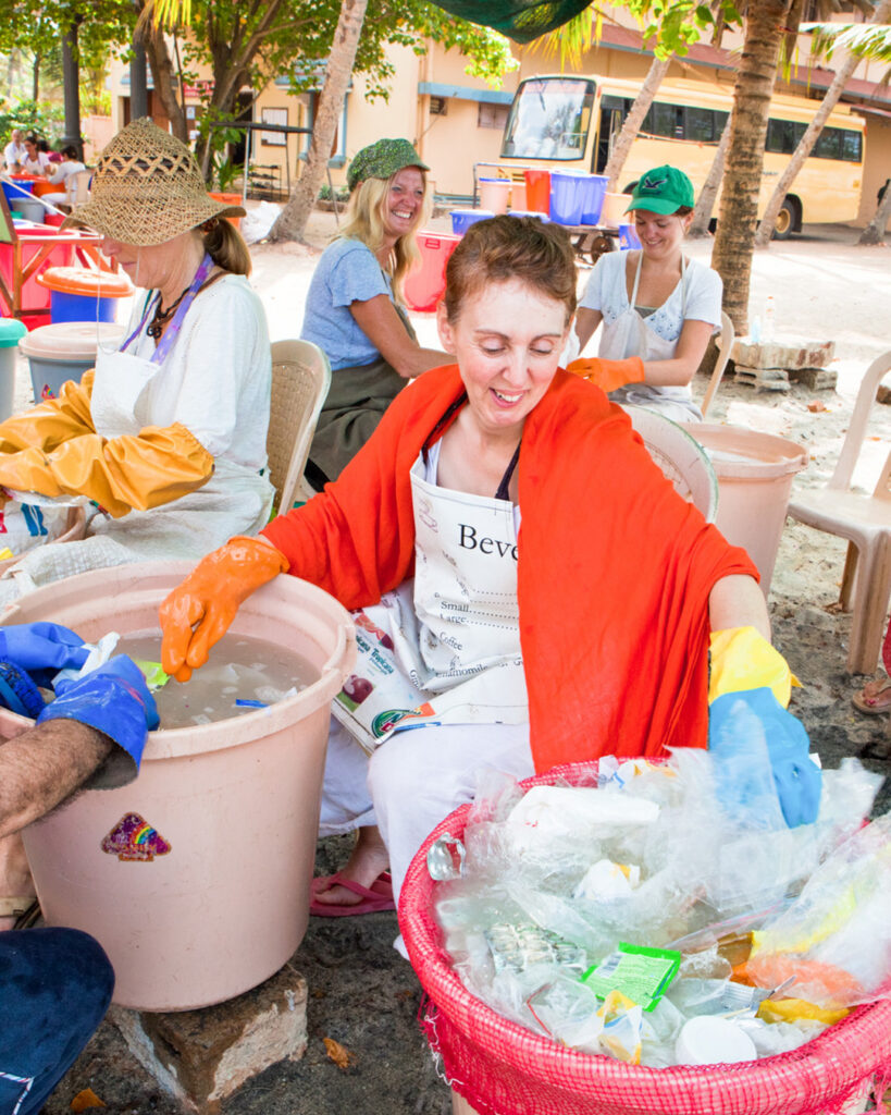 a woman sorts plastics for recycling