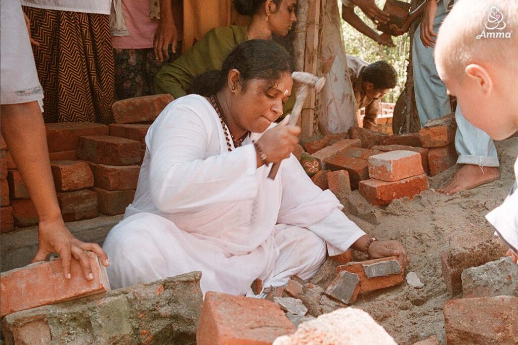 Amma hammering cement off bricks