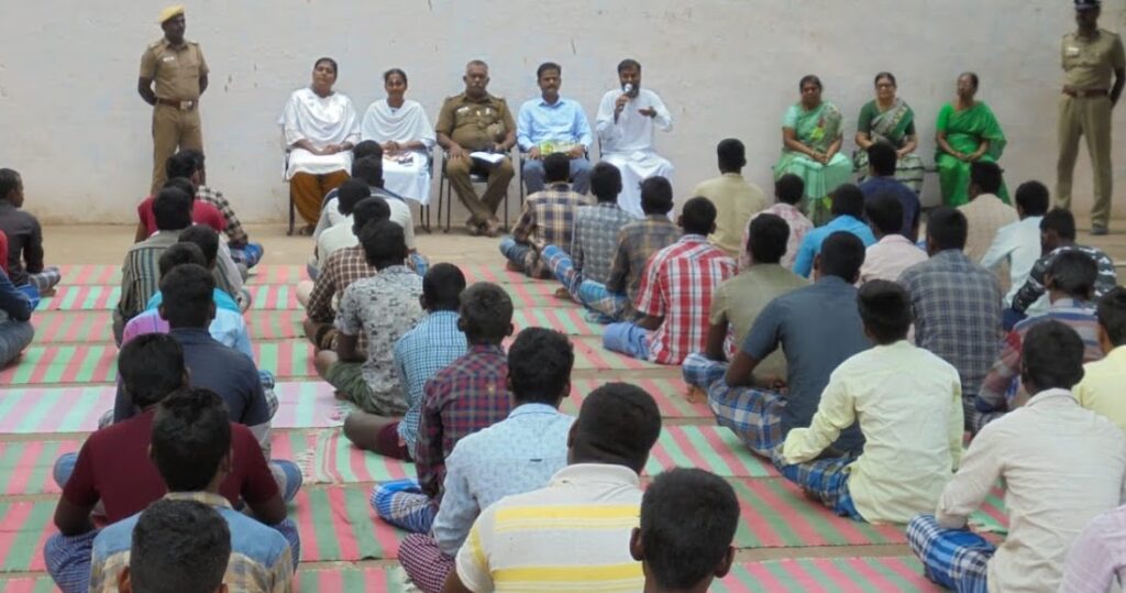 ashram volunteers speak to prisoners